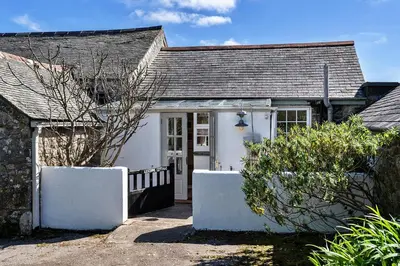 a white cottage with a gate and a door at Finest Retreats - Lesceave Cottage in Praa Sands