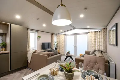 a living room with a couch and a table at Bailey Lodge in Padstow