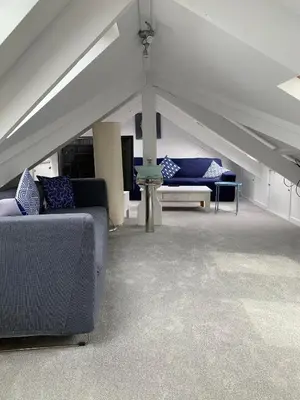 a living room with couches and tables in a tent at Harbour View in St Ives
