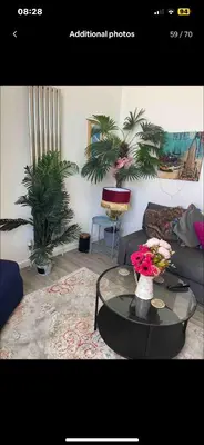 a living room with a couch and a table with flowers at Harbour View in St Ives