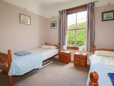 a bedroom with two beds and a window at Beachcliff in Gorran Haven