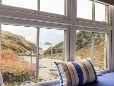 a room with a window with a view of the ocean at Cliffside in Tintagel