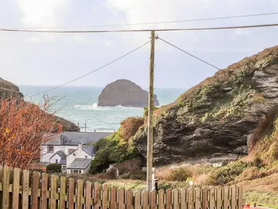 a house on a hill next to the ocean at Cliffside in Tintagel