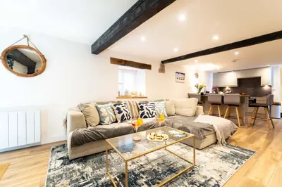 a living room with a couch and a table at The Boathouse in St Ives