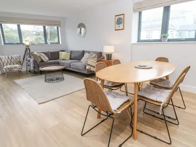a living room with a table and chairs and a couch at Sebastian's View in Falmouth