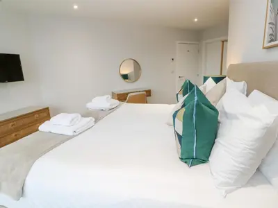 a bedroom with a large white bed with white pillows at Sebastian's View in Falmouth