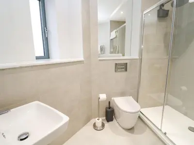 a bathroom with a toilet and a sink and a shower at Sebastian's View in Falmouth