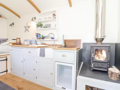 a kitchen with a wood stove in a kitchen at Gwithian Shepherds Hut in Hayle