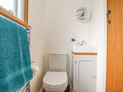 a small bathroom with a toilet and a sink at Gwithian Shepherds Hut in Hayle